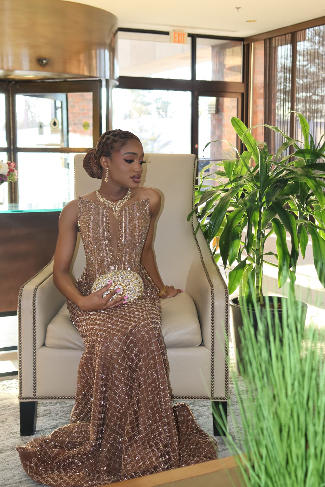 Seated lobby portrait in a beaded gold gown
