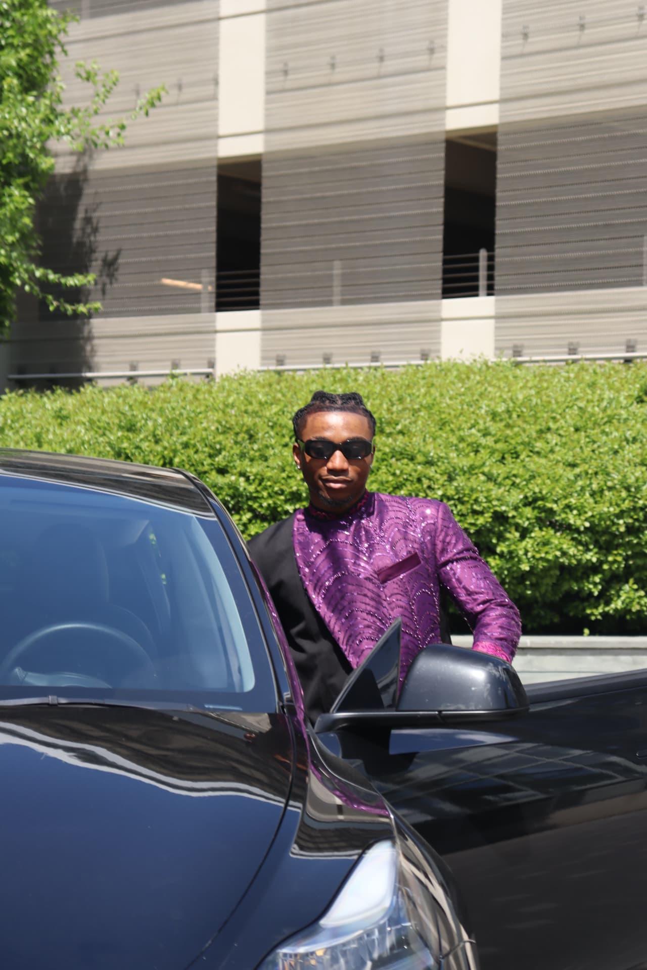 Prom send-off arrival portrait in a purple sequin jacket stepping out of the car